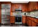 Gourmet kitchen featuring stainless steel appliances, granite countertops, and custom wood cabinets at 8369 E Del Camino Dr, Scottsdale, AZ 85258
