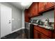 Laundry room equipped with washer, dryer, sink, granite countertop, and wood cabinets at 8369 E Del Camino Dr, Scottsdale, AZ 85258