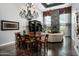 Spacious living room with high ceilings, a slate fireplace, and elegant chandelier at 8369 E Del Camino Dr, Scottsdale, AZ 85258