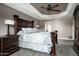 This main bedroom features a spacious layout, with an elegant bed and a tray ceiling with a fan at 8369 E Del Camino Dr, Scottsdale, AZ 85258