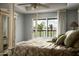 Bright main bedroom with a view of the lake and a ceiling fan at 8369 E Del Camino Dr, Scottsdale, AZ 85258