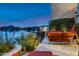 Stylish patio with outdoor seating and lush greenery, overlooking the lake at 8369 E Del Camino Dr, Scottsdale, AZ 85258