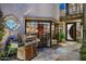Private patio with custom stonework, a built-in grill, and access to the living room at 8369 E Del Camino Dr, Scottsdale, AZ 85258