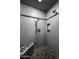 Contemporary shower with gray tile, a built-in bench, and a niche for storing shower products at 8369 E Del Camino Dr, Scottsdale, AZ 85258