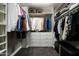 Organized walk-in closet with ample hanging space, shelving, drawers, and dark carpeting at 8369 E Del Camino Dr, Scottsdale, AZ 85258