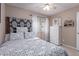 Bedroom featuring a large patterned headboard and bright white furniture and window treatments at 8568 W Purdue Ave, Peoria, AZ 85345