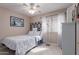 Bedroom featuring a ceiling fan, window, and neutral walls with blue accents at 8568 W Purdue Ave, Peoria, AZ 85345