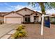 Charming home with a well-manicured front yard, colorful flower beds, and a welcoming entrance at 8568 W Purdue Ave, Peoria, AZ 85345