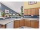 Kitchen featuring ample counter space, oak cabinets, and a plant display, ideal for culinary enthusiasts and plant lovers at 8568 W Purdue Ave, Peoria, AZ 85345