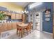 Kitchen with ample wood cabinets, a dining table, and a sliding glass door leading to an outdoor area, offering a cozy and bright space at 8568 W Purdue Ave, Peoria, AZ 85345