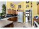 A fully-equipped kitchen with oak cabinets, a white refrigerator, and decorative items, creating a warm and inviting atmosphere at 8568 W Purdue Ave, Peoria, AZ 85345
