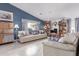 Comfortable living room with a vaulted ceiling, bookshelves, providing a relaxing space for Gathering and friends at 8568 W Purdue Ave, Peoria, AZ 85345