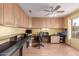 Spacious home office with built in cabinets, desk space, and a ceiling fan at 8568 W Purdue Ave, Peoria, AZ 85345