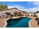 Backyard view of a sparkling swimming pool featuring unique rock features and a serene outdoor living space at 8568 W Purdue Ave, Peoria, AZ 85345