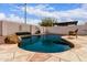 Stunning backyard swimming pool surrounded by decorative stone, landscaping, and a relaxing desert setting at 8568 W Purdue Ave, Peoria, AZ 85345