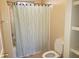 Bathroom features a shower with a striped curtain and a toilet, complemented by built in shelves at 9253 N Firebrick Dr # 143, Fountain Hills, AZ 85268