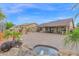 Expansive backyard featuring a water feature, mature landscaping, and ample space for outdoor living and entertaining at 9740 W Rockwood Dr, Peoria, AZ 85382