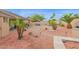 Spacious landscaped backyard featuring a brick patio, mature palms, and a serene water feature at 9740 W Rockwood Dr, Peoria, AZ 85382