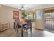 Cozy dining room with tile flooring, a ceiling fan, and direct access to an outdoor patio at 9740 W Rockwood Dr, Peoria, AZ 85382