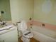 Bathroom with a bathtub, toilet, and sink at 10319 W Willie Low Cir, Sun City, AZ 85351