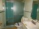 Bathroom featuring a glass-enclosed shower, toilet and sink at 10319 W Willie Low Cir, Sun City, AZ 85351