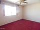 Bedroom featuring a large window and carpeted flooring at 10319 W Willie Low Cir, Sun City, AZ 85351