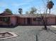 Charming single-story home with a well-kept desert landscaped front yard and rock at 10319 W Willie Low Cir, Sun City, AZ 85351
