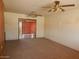 Spacious living room featuring a ceiling fan and large opening to the dining area at 10319 W Willie Low Cir, Sun City, AZ 85351