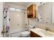 Functional bathroom features a tub-shower combination and wood-trimmed vanity at 10440 W Devonshire Ave, Phoenix, AZ 85037