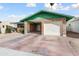 Single-story brick home with a covered parking area, a garage, and an expansive driveway at 10440 W Devonshire Ave, Phoenix, AZ 85037