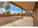 Covered back patio with desert landscaping, offering a relaxing outdoor space at 15026 W Cactus Ridge Way, Surprise, AZ 85374