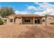 The backyard features a covered patio, desert landscaping, and views at 15026 W Cactus Ridge Way, Surprise, AZ 85374