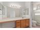 Bright bathroom with a spacious vanity, large mirror, and walk-in shower at 15026 W Cactus Ridge Way, Surprise, AZ 85374