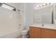 Bathroom featuring a bath and shower, light wood cabinets, and neutral color palette at 15026 W Cactus Ridge Way, Surprise, AZ 85374