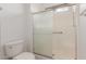 Bright bathroom featuring a glass shower door, tiled shower and neutral color palette at 15026 W Cactus Ridge Way, Surprise, AZ 85374