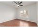 Bedroom featuring wood floors, large window, ceiling fan and neutral paint at 15026 W Cactus Ridge Way, Surprise, AZ 85374