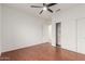 Bedroom featuring wood floors, ceiling fan, and closet space at 15026 W Cactus Ridge Way, Surprise, AZ 85374