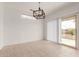 Dining room featuring a modern light fixture and sliding glass doors to the outdoor area at 15026 W Cactus Ridge Way, Surprise, AZ 85374