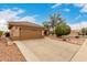 Charming single-story home with a well-maintained lawn and large driveway leading to a two-car garage at 15026 W Cactus Ridge Way, Surprise, AZ 85374