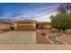 Charming single-story home with a xeriscaped front yard and tile roof at 15026 W Cactus Ridge Way, Surprise, AZ 85374