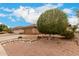 Single story home featuring xeriscape front yard, mature shade tree, and tile roof at 15026 W Cactus Ridge Way, Surprise, AZ 85374
