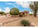 Single story home featuring xeriscape front yard, mature shade tree, and tile roof at 15026 W Cactus Ridge Way, Surprise, AZ 85374