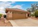 Attached garage with paneled door and concrete driveway of this single Gathering home with terra cotta tile roof at 15026 W Cactus Ridge Way, Surprise, AZ 85374