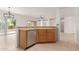 Open kitchen with stainless steel dishwasher and view of the attached living spaces at 15026 W Cactus Ridge Way, Surprise, AZ 85374