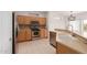 Bright kitchen with stainless steel appliances, light wood cabinets, and tiled flooring at 15026 W Cactus Ridge Way, Surprise, AZ 85374