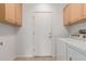 Laundry room featuring cabinets above white washer and dryer at 15026 W Cactus Ridge Way, Surprise, AZ 85374