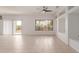 Bright living room with tile flooring, ceiling fan, and a large window offering natural light at 15026 W Cactus Ridge Way, Surprise, AZ 85374