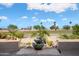 Well-manicured backyard featuring tiered water fountain and golf course views at 15560 W Clear Canyon Dr, Surprise, AZ 85374