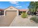 Charming single-story home with a tile roof, neutral stucco, two car garage, and easy care desert landscaping at 15560 W Clear Canyon Dr, Surprise, AZ 85374