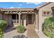 Inviting home entrance with stone accents, a tile roof, desert landscaping, and covered front entryway at 15560 W Clear Canyon Dr, Surprise, AZ 85374